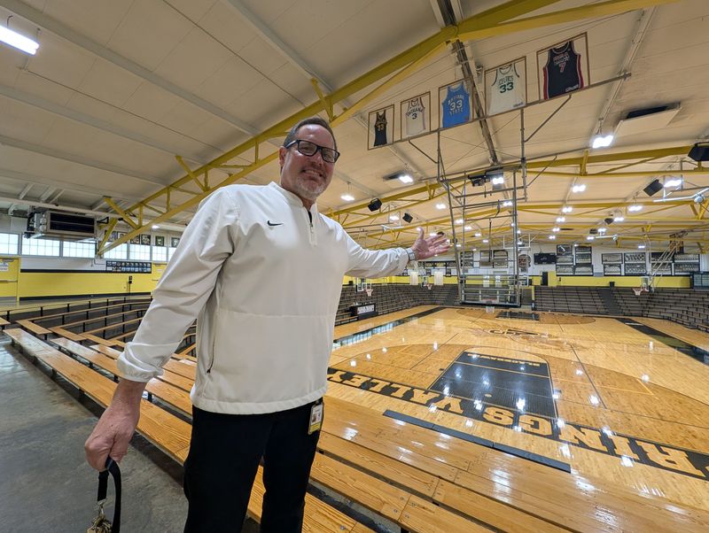 Springs Valley High School athletic director Jerry Chaney stands below the retired jerseys of Larry Bird in French Lick, Indiana on Tuesday, April 28, 2026.