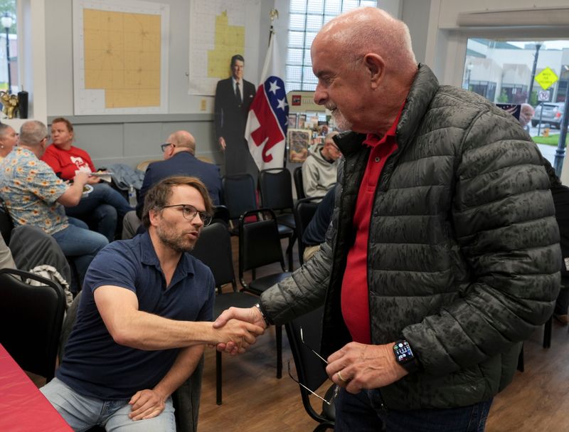Indiana State Sen. Travis Holdman, R-Markle, (right) shakes Wells County council candidate Brandon Harnish’s hand during an election watch party Tuesday, May 5, 2026, at the Wells County Republican Headquarters in Bluffton.