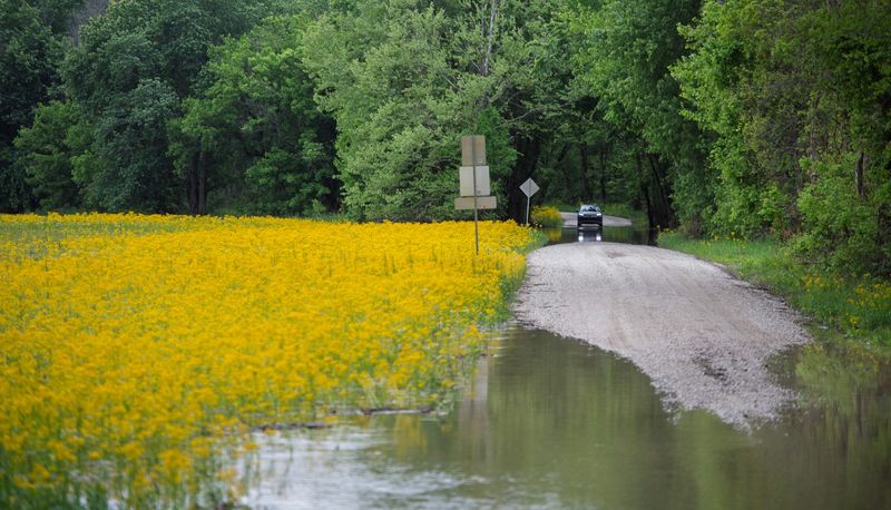 A vehicle approaches the flooded area of Friendship Road on Wednesday, May 6, 2026.