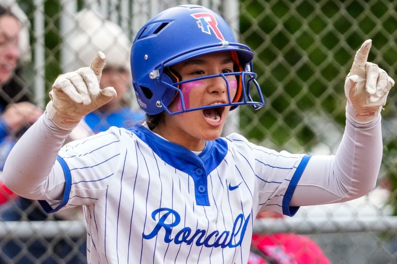 Roncalli Royals Elise Baker (4) celebrates a run Wednesday, May 6, 2026, during a softball game at Roncalli High School in Indianapolis. The Roncalli Royals defeated the New Palestine Dragons, 6-3.