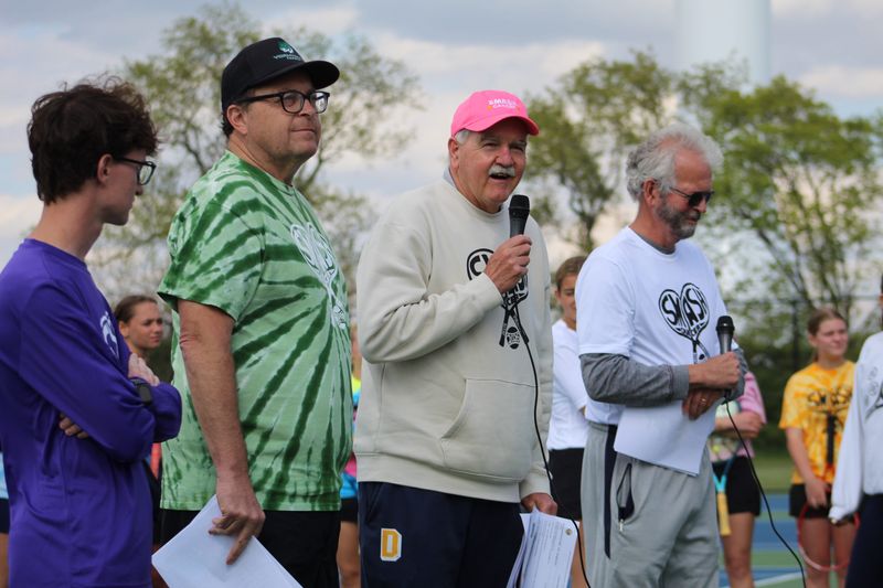 Delta girls tennis coach Tim Cleland addresses the crowd during the 14th annual Smash Cancer match at the Yorktown Sports Complex tennis courts on Thursday, May 7, 2026.
