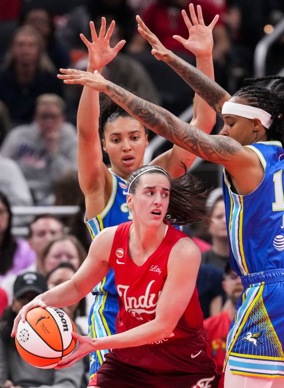 Indiana Fever guard Caitlin Clark (22) looks to pass around Dallas Wings guard Azzi Fudd (35) and Dallas Wings guard Aziaha James (10) on Saturday, May 9, 2026, during the first half of the Fever’s season opener game at Gainbridge FIeldhouse in Indianapolis.