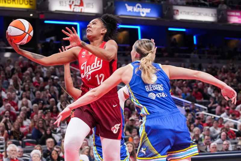 Indiana Fever center-forward Damiris Dantas (12) goes up for a basket against Dallas Wings guard Paige Bueckers (5) on Saturday, May 9, 2026, during the second half of the Fever’s season opener game at Gainbridge Fieldhouse in Indianapolis. The Dallas Wings defeated the Indiana Fever, 107-104.