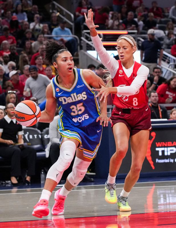 Dallas Wings guard Azzi Fudd (35) drives against Indiana Fever guard Sophie Cunningham (8) on Saturday, May 9, 2026, during the first half of the Fever’s season opener game at Gainbridge Fieldhouse in Indianapolis. The Dallas Wings defeated the Indiana Fever, 107-104.