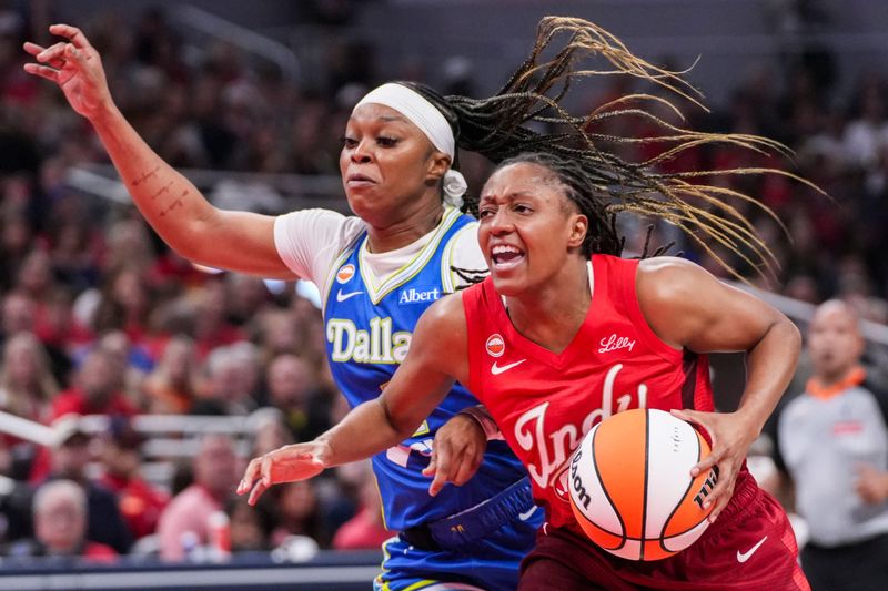 Dallas Wings guard Odyssey Sims (1) guards Indiana Fever guard Kelsey Mitchell (0) on Saturday, May 9, 2026, during the second half of the Fever’s season opener game at Gainbridge Fieldhouse in Indianapolis. The Dallas Wings defeated the Indiana Fever, 107-104.