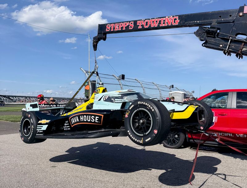 The car of Ed Carpenter Racing driver Alexander Rossi (20) is towed after it died on the track Saturday, May 9, 2026, during the Sonsio Grand Prix at Indianapolis Motor Speedway.