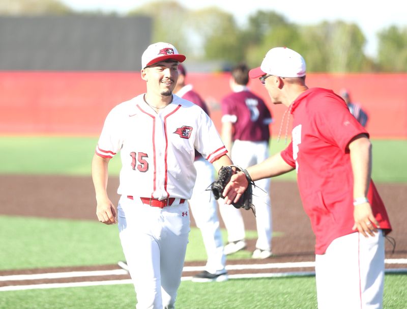 Goshen senior starting pitcher Ryen Diaz gives head coach JJ DuBois a fist bump coming off the mound during a home baseball game vs. Mishawaka Monday, May 11, 2026.