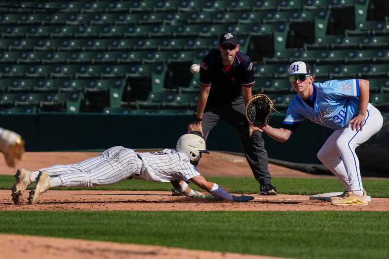 Cathedral Fighting Irish infielder Eli Sinsabaugh (9) dives back toward first base against Heritage Christian Eagles Isaac Marshall (30) on Tuesday, May 12, 2026, during the City Tournament Championship at Victory Field in Indianapolis. The Cathedral Fighting Irish defeated the Heritage Christian Eagles, 11-10.