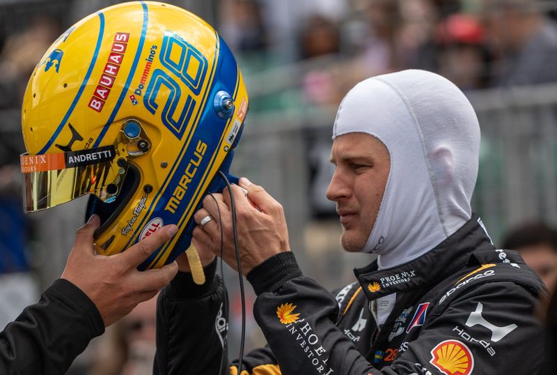 Andretti Global driver Marcus Ericsson (28) puts on his helmet Wednesday, May 13, 2026, during practice for the 110th running of the Indianapolis 500 at Indianapolis Motor Speedway.