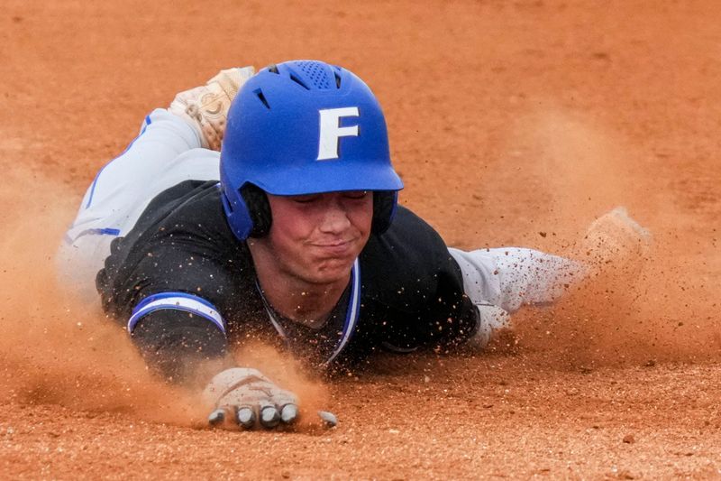 Franklin Grizzly Cubs Carsten Bland (9) dives into third base Wednesday, May 13, 2026, during a game at Greenwood Community High School. The Franklin Grizzly Cubs defeated the Greenwood Woodmen, 9-0.