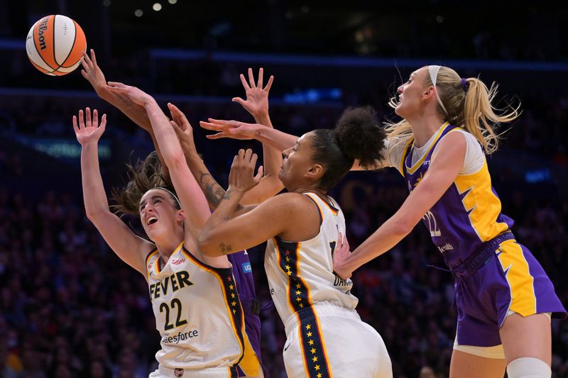 May 13, 2026; Los Angeles, California, USA; Indiana Fever guard Caitlin Clark (22), center Damiris Dantas (12), Los Angeles Sparks guard Rae Burrell (12) and forward Cameron Brink (22) battle for a rebound in the first half at Crypto.com Arena. Mandatory Credit: Jayne Kamin-Oncea-Imagn Images