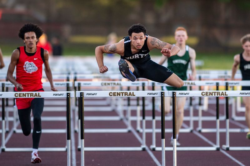 Runners compete in the 110 meter hurdles during the SIAC Boys Track and Field meet at Central High School in Evansville, Ind., Thursday, May 14, 2026.