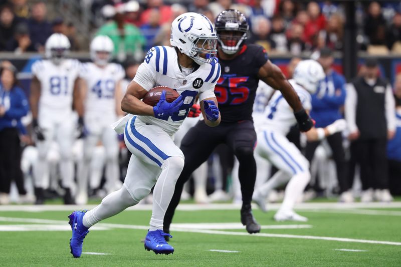 Jan 4, 2026; Houston, Texas, USA; Indianapolis Colts running back Jonathan Taylor (28) carries the ball against the Houston Texans during the first half at NRG Stadium. Mandatory Credit: Troy Taormina-Imagn Images