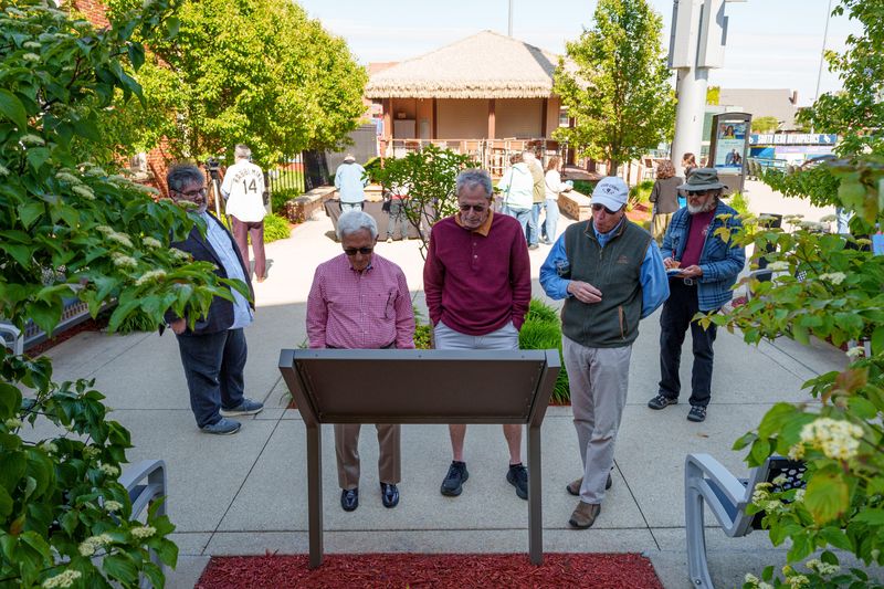 People read the historical marker for the song "Take Me Out to the Ball Game" at Four Winds Field on Friday, May 15, 2026, in South Bend.