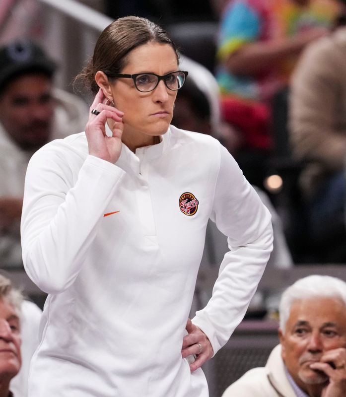 Indiana Fever head coach Stephanie White listens from the sideline Friday, May 15, 2026, during the first half of a game at Gainbridge Fieldhouse in Indianapolis.