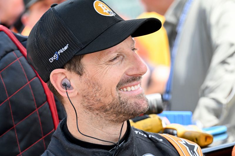 Dale Coyne Racing driver Romain Grosjean (18) smiles as he waits to qualify Sunday, May 17, 2026, during qualifying for the 110th running of the Indianapolis 500 at Indianapolis Motor Speedway.