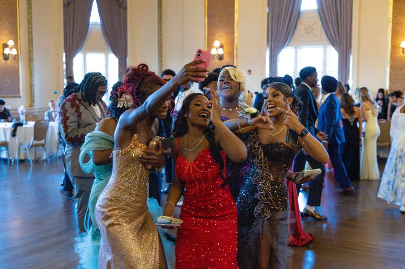 Students film themselves on the dance floor at the Adams High School prom at the Palais Royale Friday, May 15, 2026.