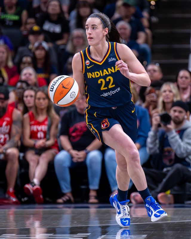 Indiana Fever guard Caitlin Clark (22) brings the ball up court during the first half of an WNBA basketball game against the Seattle Storm, Sunday, May 17, 2026, at Gainbridge Fieldhouse.