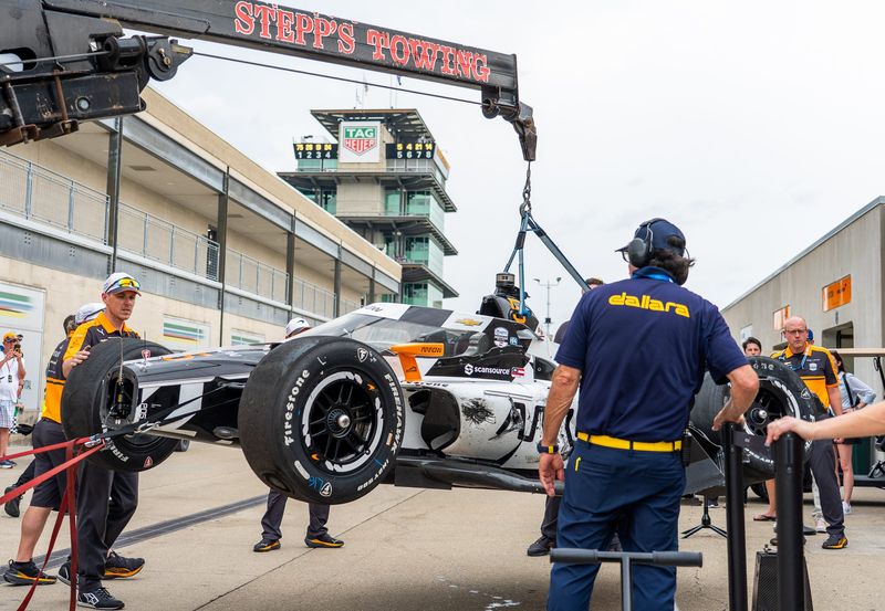 The car of Arrow McLaren driver Pato O'Ward (5) is lifted into the team’s garage Monday, May 18, 2026, after a crash during practice for the 110th running of the Indianapolis 500 at Indianapolis Motor Speedway.