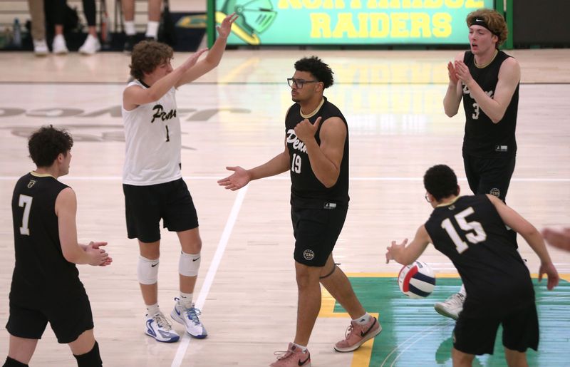 The Penn boys volleyball team surrounds senior Christian Bonner (19) in celebration during IHSAA sectionals Saturday, May 16, 2026, at Northridge High School.
