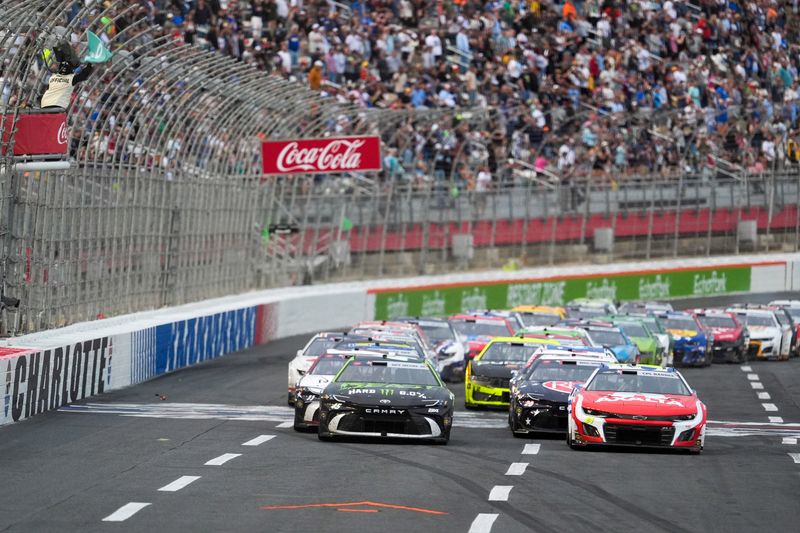 May 25, 2025; Concord, North Carolina, USA; Green flag restart with NASCAR Cup Series driver William Byron (24) and driver Tyler Reddick (45) in front of the field during the Coca Cola 600 at Charlotte Motor Speedway. Mandatory Credit: Jim Dedmon-Imagn Images