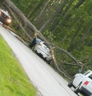 A screenshot shows a portion of a video taken by passing motorist Badayah Brazelton after an uprooted tree fell on a passing car, severely injuring a LaPorte woman.