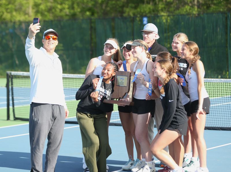 The South Bend Saint Joseph girls tennis team celebrates after wining an IHSAA sectional championship match against Glenn Thursday, May 21, 2026, at Mishawaka Marian High School.