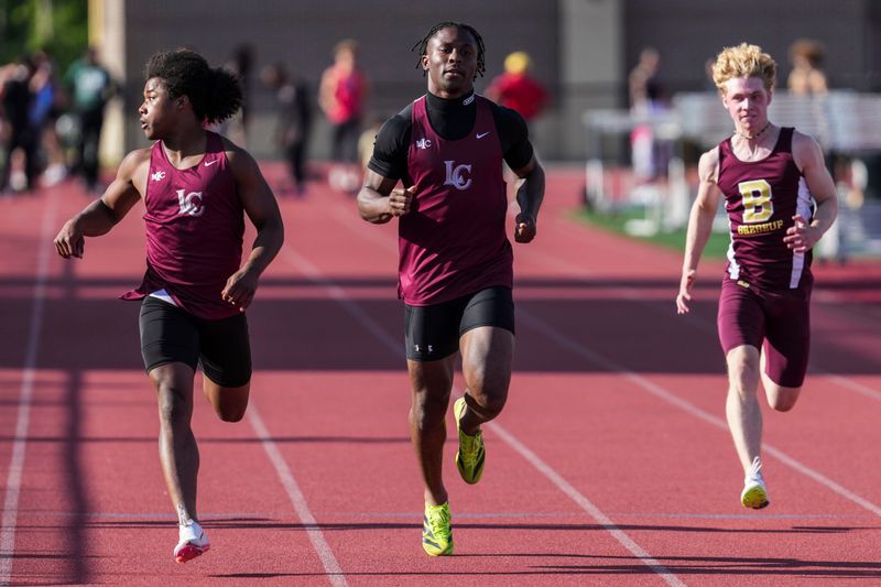 Lawrence Central’s Errol Kerns competes in the 100-meter dash preliminaries race Thursday, May 21, 2026, during an IHSAA track and field sectionals meet at Lawrence Central High School in Indianapolis.