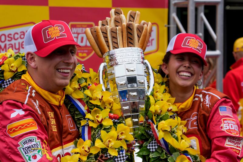 The New York dog team celebrates the wind during the Wienie 500 Friday, May 22, 2026, on Carb Day ahead of the 110th running of the Indianapolis 500 at Indianapolis Motor Speedway.