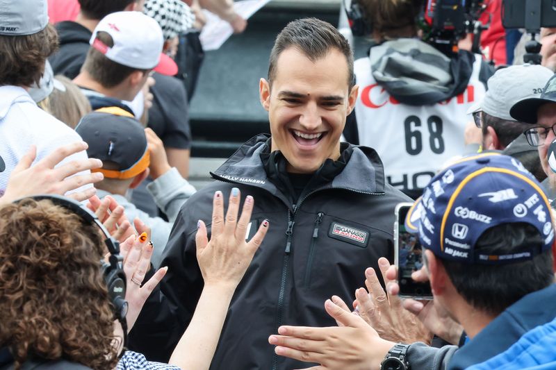 Chip Ganassi Racing driver Alex Palou (10) walks down the grandstands and high five fans on Saturday, May 23, 2026, during a drivers meeting ahead of the 110th running of the Indianapolis 500 at Indianapolis Motor Speedway.
