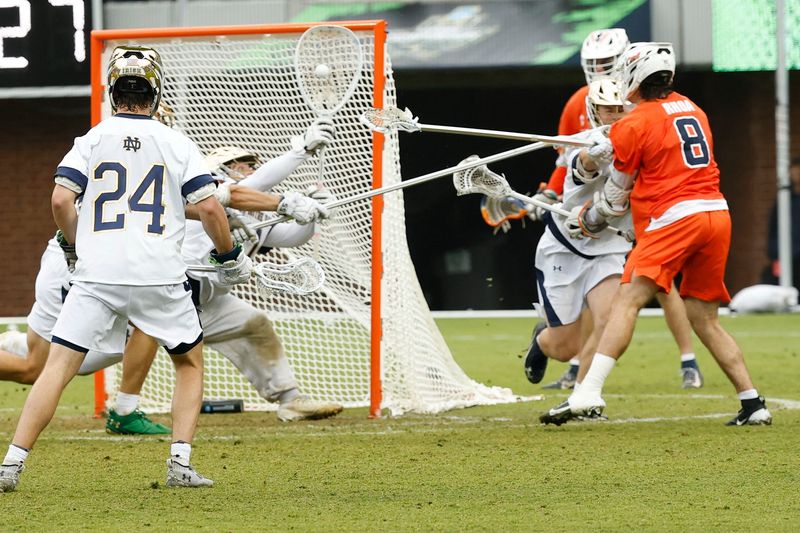 May 23, 2026; Charlottesville, VA, USA; Notre Dame Fighting Irish goalie Thomas Ricciardelli (1) makes a save on Syracuse Orange midfielder Luke Rhoa (8) during the second half in a semifinal of the NCAA Mens Lacrosse Championship at Scott Stadium. Mandatory Credit: Geoff Burke-Imagn Images