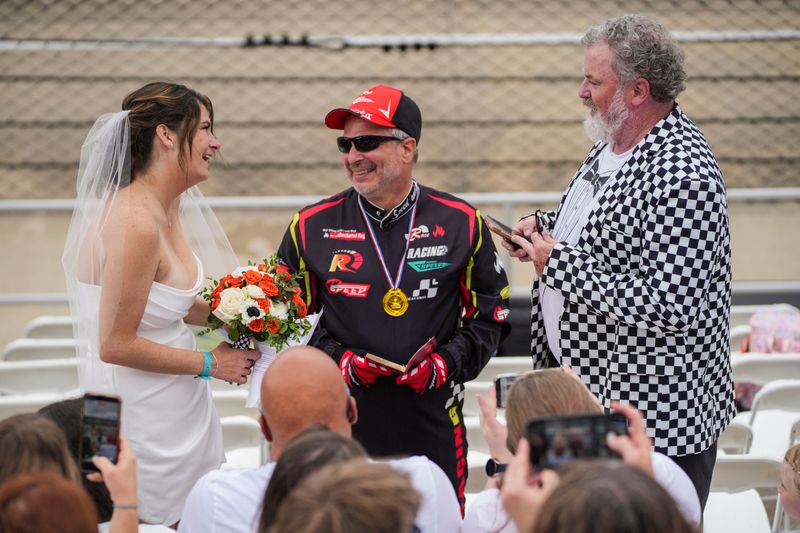 Kara Geideman and Dr. Bert O'Neil of Hamilton County get married in the grandstands Sunday, May 24, 2026, ahead of the 110th running of the Indianapolis 500 at Indianapolis Motor Speedway.