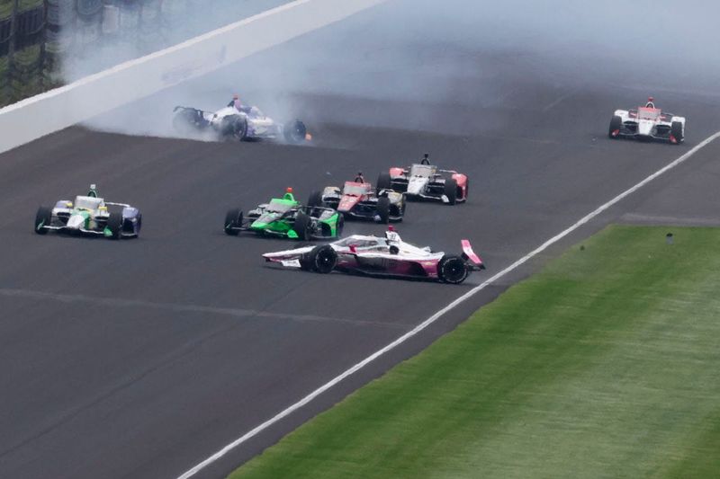 Arrow McLaren driver Ryan Hunter-Reay (31) and HMD Motorsports with AJ Foyt Racing driver Katherine Legge (11) crash on the exit of the second turn Sunday, May 24, 2026, during the 110th running of the Indianapolis 500 at Indianapolis Motor Speedway.