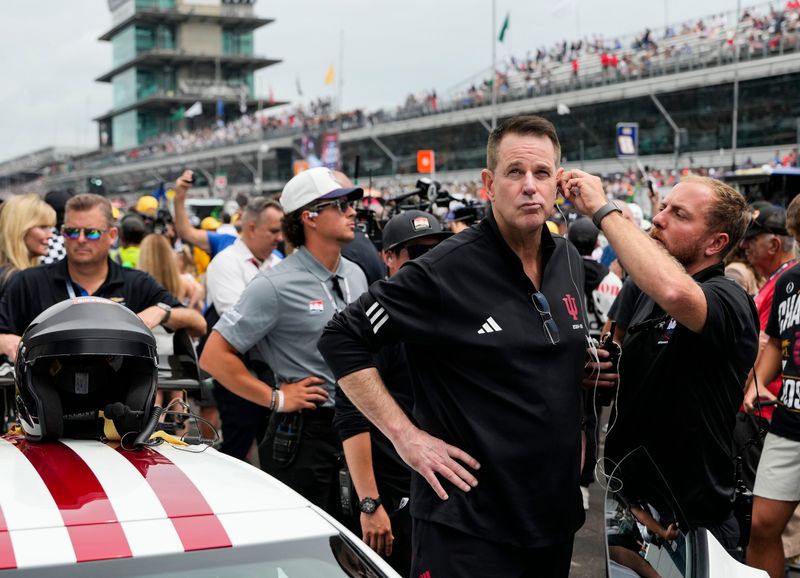 Indiana University's Curt Cignetti stands outside the pace car as in ear monitors are fitted to his ears Sunday, May 24, 2026, ahead of the 110th running of the Indianapolis 500 at Indianapolis Motor Speedway.