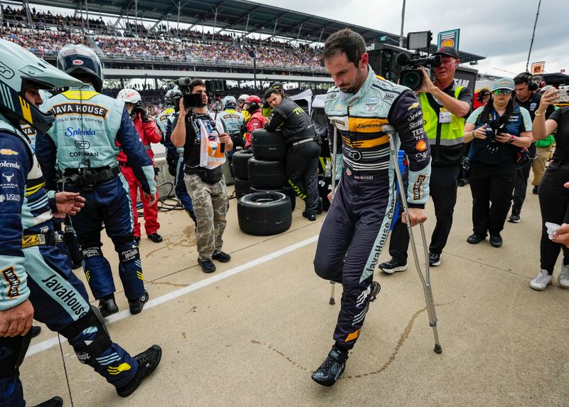Ed Carpenter Racing driver Alexander Rossi (20) uses crutches to move down pit lane Sunday, May 24, 2026, ahead of the 110th running of the Indianapolis 500 at Indianapolis Motor Speedway. Rossi's car failed in the pits, ending his day.