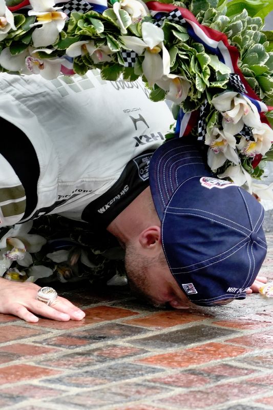 Felix Rosenqvist kisses the bricks Saturday, May 24, 2026, after the 110th running of the Indianapolis 500 at Indianapolis Motor Speedway.