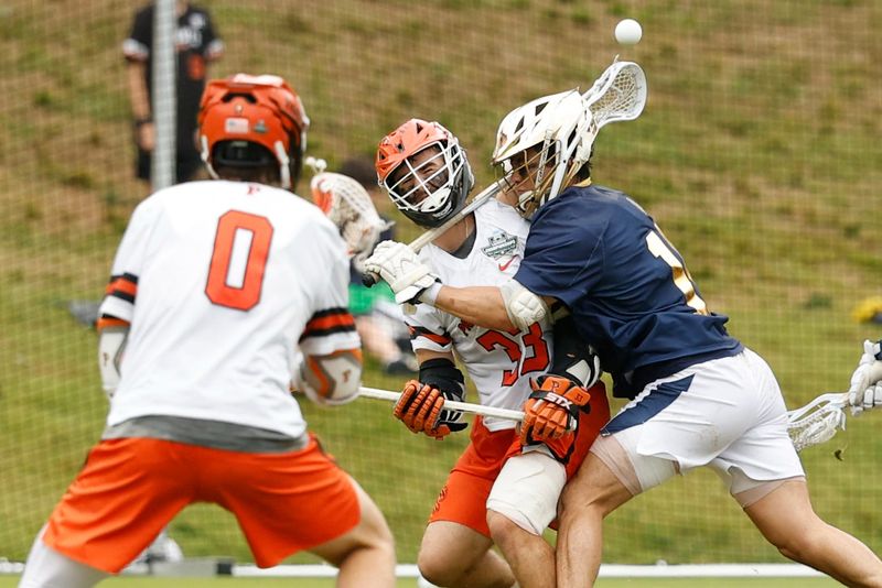 May 25, 2026; Charlottesville, VA, USA; Notre Dame Fighting Irish midfielder Christian Alacqua (19) cross-checks Princeton Tigers attack Porter Malkiel (33) during the second quarter in the NCAA Mens Lacrosse National Championship game at Scott Stadium. Mandatory Credit: Geoff Burke-Imagn Images