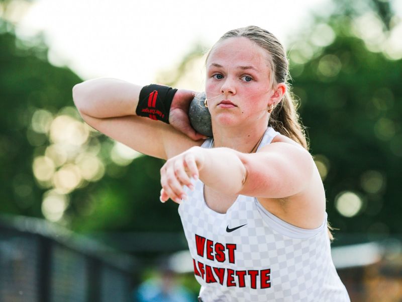 West Lafayette thrower Audrey Alexander braces the shot put on her neck while preparing to throw at the IHSAA girls track & field regional at Jeff High School on May 26, 2026.