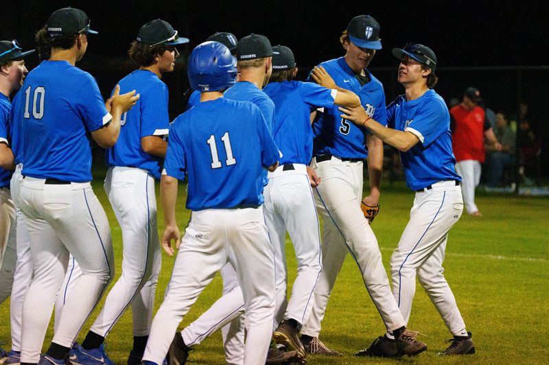 Marian's Isaac Gill (5) celebrates with teammates after winning an IHSAA baseball sectional opener 3-1 against John Glenn at Bill Nixon Field Wednesday, May 27, 2026, in Plymouth.