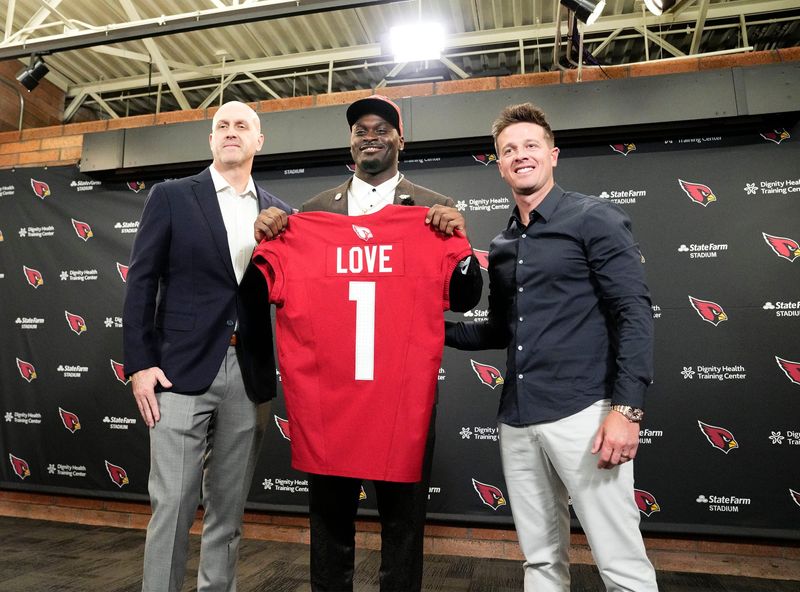 Arizona Cardinals general manager Monti Ossenfort and head coach Mike LaFleur (right) introduce their first-round draft pickÂ running back Jeremiyah LoveÂ during a news conference at the Cardinals Dignity Health training facility on April 24, 2026, in Tempe, Ariz.