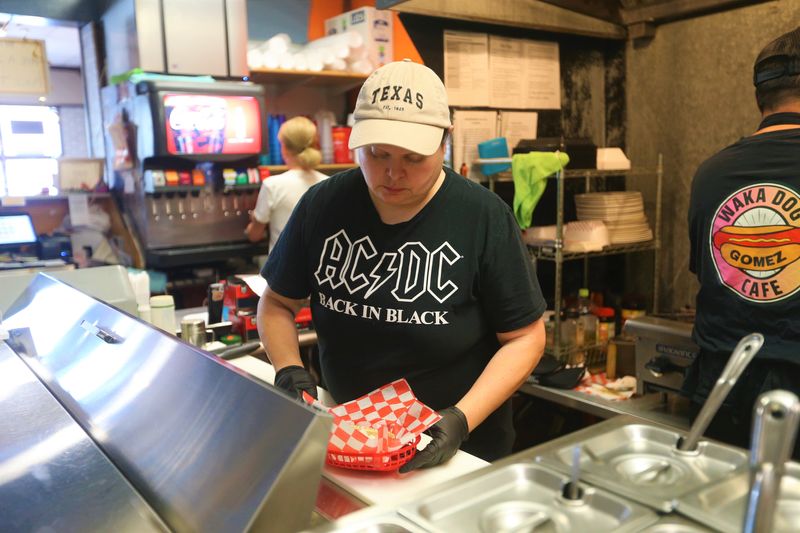 Angel Gomez makes a Chicago dog at Waka Dog Cafe on May 26, 2026 in South Bend.
