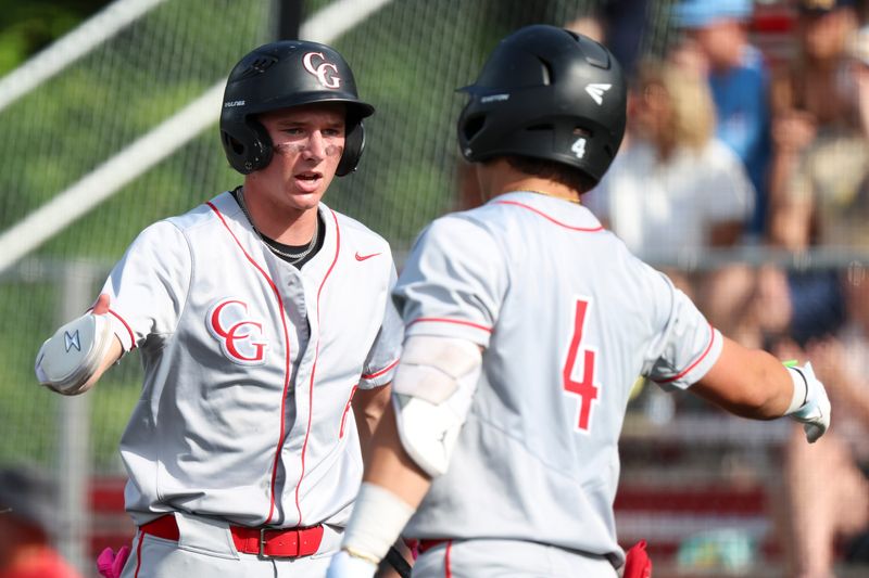 Center Grove shortstop Grady Grant (6) high fives catcher Tristan Yerman (4) after scoring a run on Saturday, May 30, 2026, during a sectional semifinal game at Center Grove High School in Greenwood, Ind. Center Grove defeated Mooreseville, 6-2.