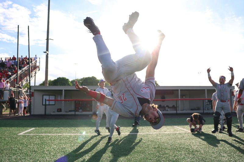 Center Grove left fielder Hudson Stewart (26) flips while celebrating a win on Saturday, May 30, 2026, during a sectional semifinal game at Center Grove High School in Greenwood, Ind. Center Grove defeated Mooreseville, 6-2.