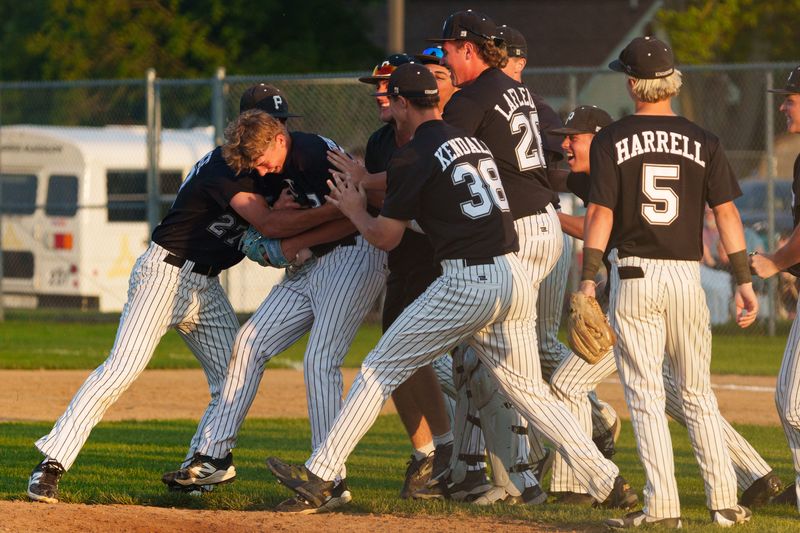 Penn celebrates with Anthony Biancardi, second from left, after winning an IHSAA baseball sectional championship game 9-3 against Mishawaka at Ward Baker Park Monday, June 1, 2026, in Mishawaka.