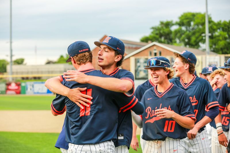 Teammates continue to hug Colton Watts in celebration of his game-saving pitching effort in the IHSAA sectional championship game at Loeb Stadium on June 1, 2026.
