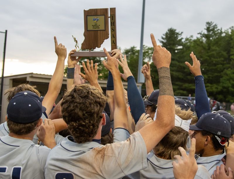 Lafayette Central Catholic hoists the championship trophy on Monday, June 1, 2026, following the sectional 37 championship game at North Montgomery High School in Crawfordsville, Indiana. Lafayette Central Catholic defeated North Montgomery, 8-0.