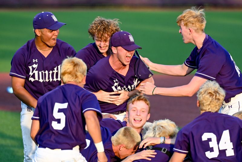 Bloomington South’s Amos Ewer (22) and Xavier Hemingway (26) celebrate with Connor Couch (20) after defeating Bloomington North in the sectional championship game at South on Monday, June 1, 2026.