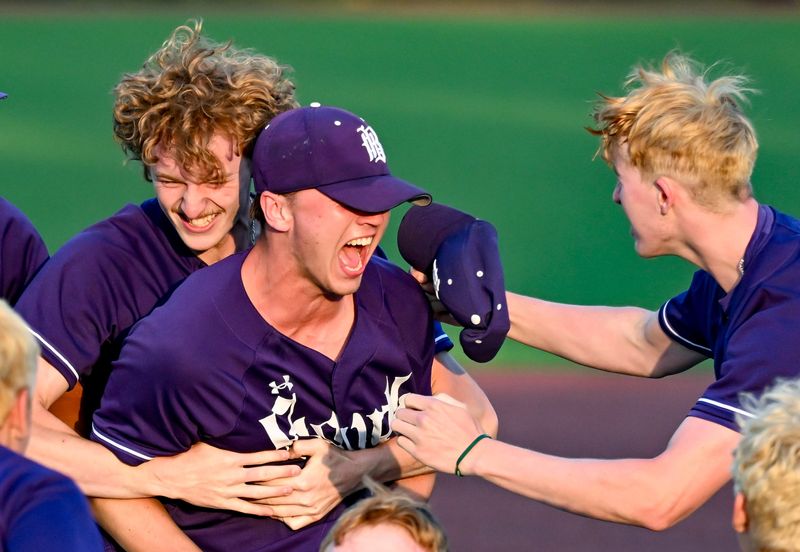 Bloomington South’s Amos Ewer (22) and Xavier Hemingway (26) celebrate with Connor Couch (20) after defeating Bloomington North in the sectional championship game at South on Monday, June 1, 2026.
