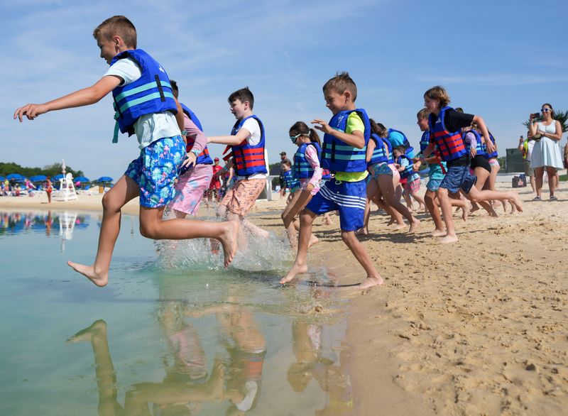 Kids enter the water for the first time as the water park opens Thursday, June 4, 2026, at SKYLAKE Adventures in Sheridan, Ind.