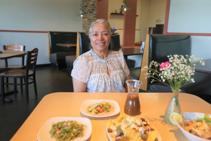Amparo Fernandez sits next to food she made at Mami Mari's on June 4, 2026, in South Bend.